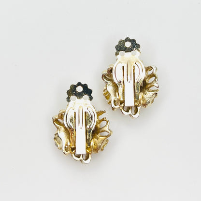 Back of vintage 1950s gold-tone clip-on earrings with secure clips.