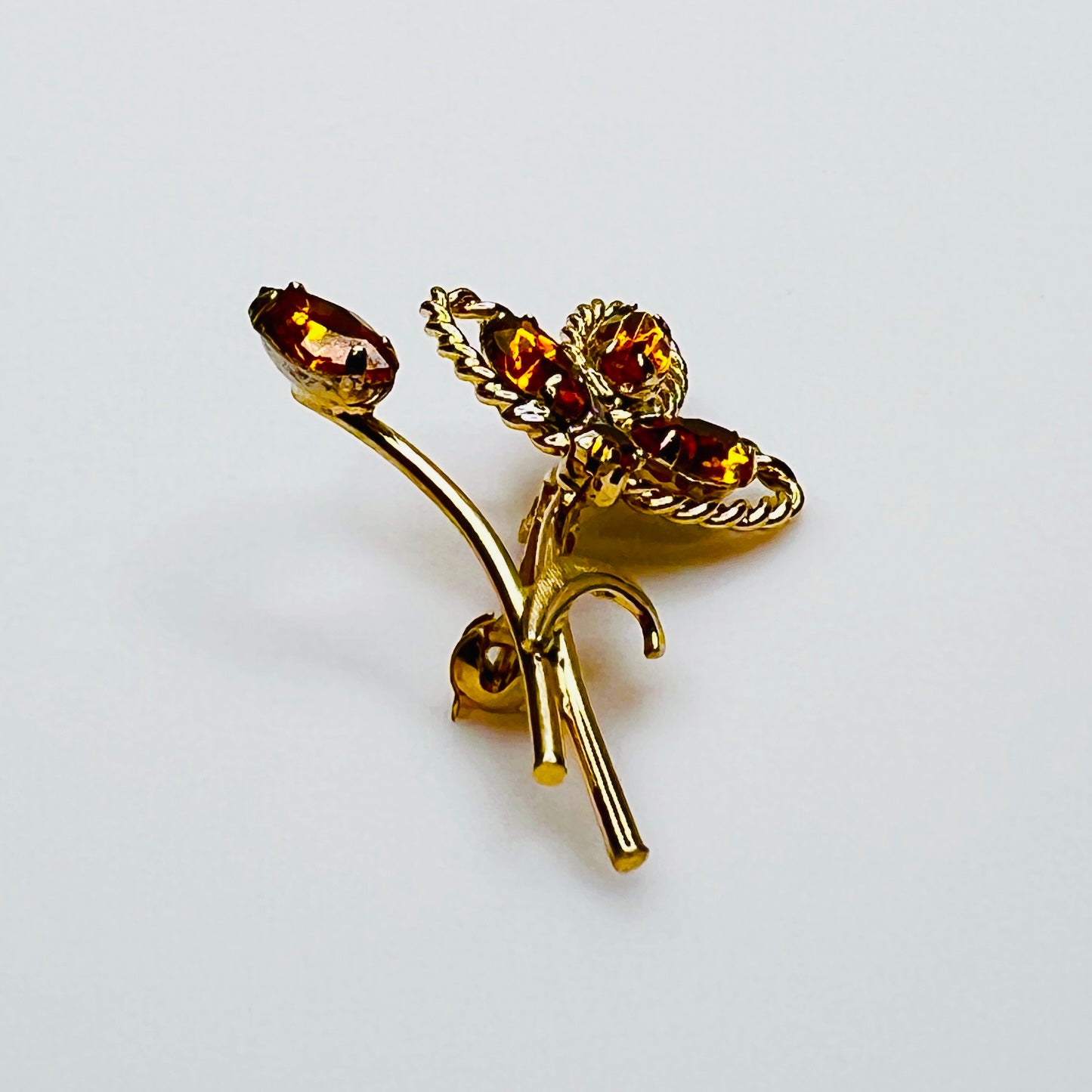 Side profile of amber rhinestone brooch