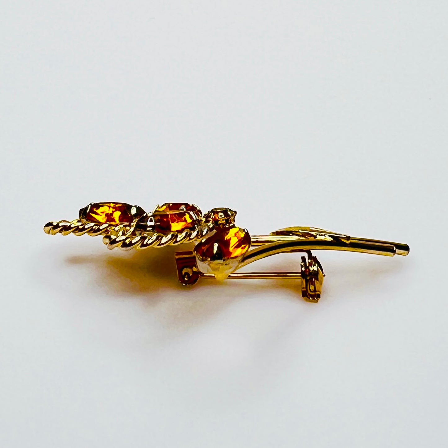 Side profile of amber rhinestone brooch