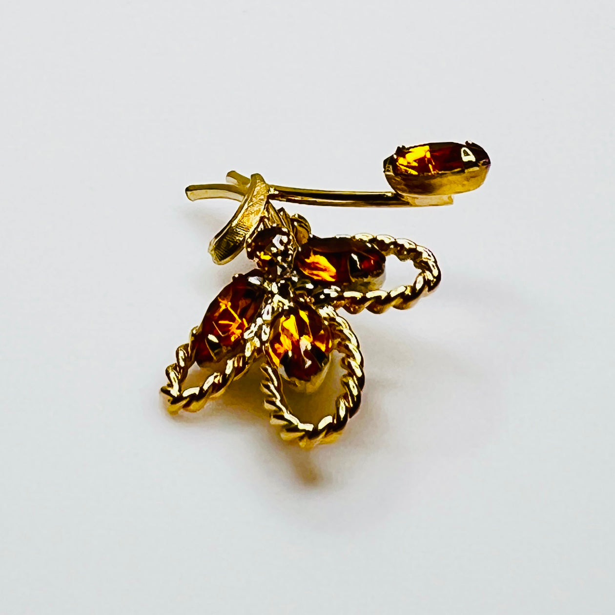 Side profile of amber rhinestone brooch