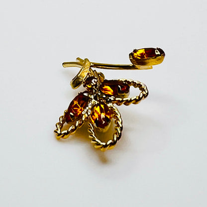 Side profile of amber rhinestone brooch