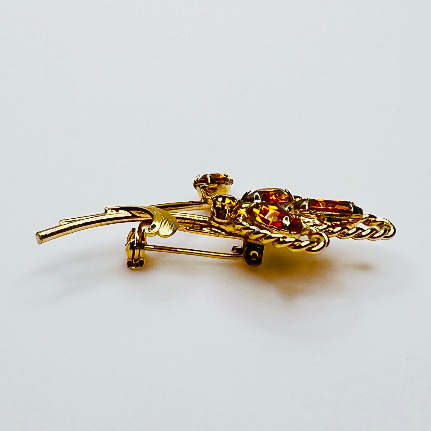 Side profile of amber rhinestone brooch