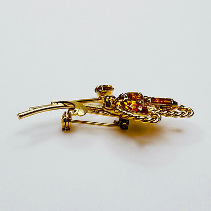 Side profile of amber rhinestone brooch