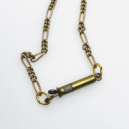 Close-up of vintage gold tone chain with brass barrel clasp.