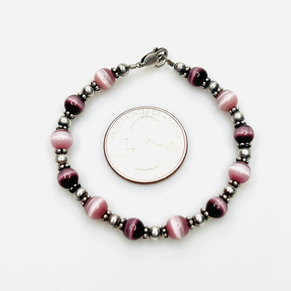 Purple cat's eye sterling silver bracelet shown with quarter for scale