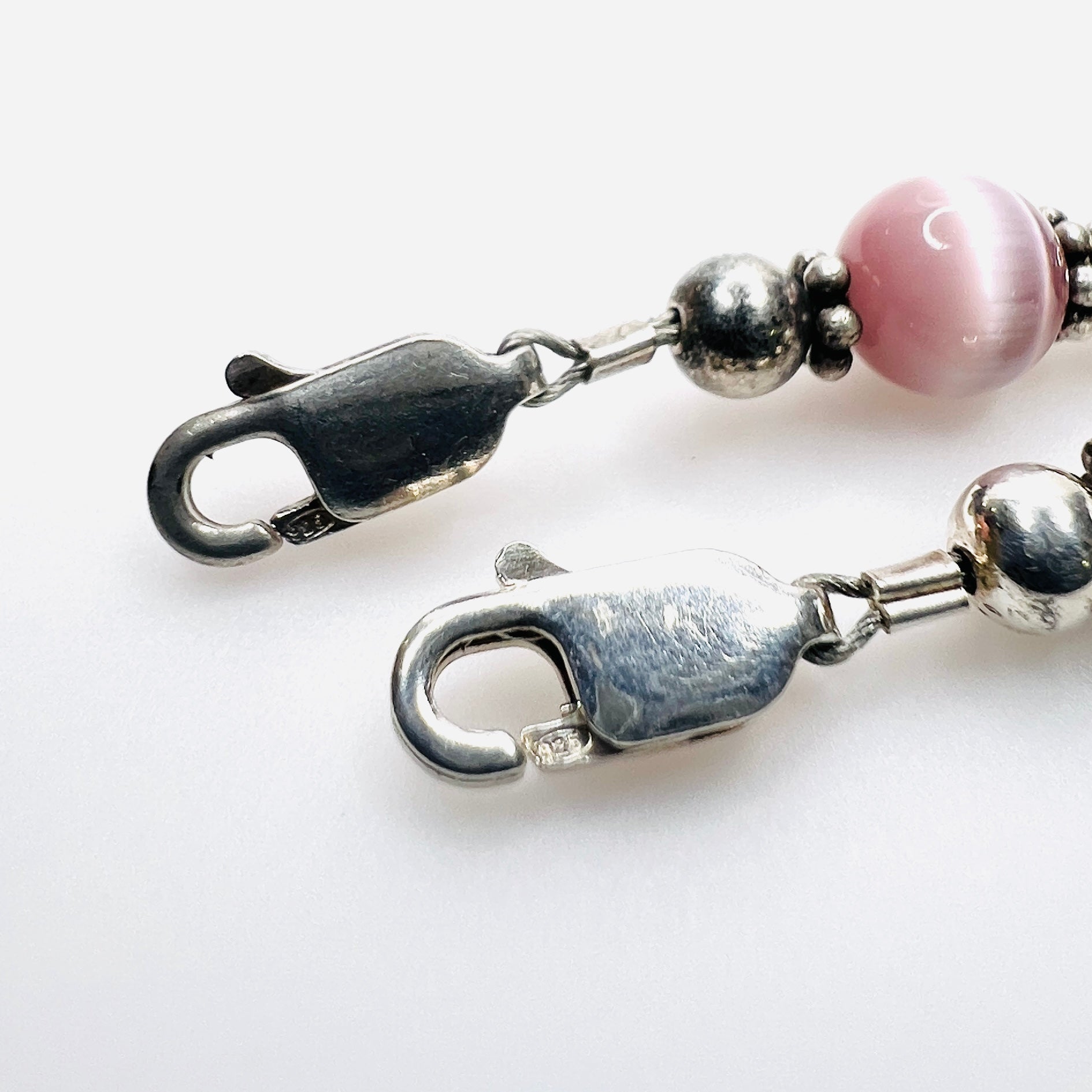 Close up of  925 mark on lobster claw clasp of sterling silver cats eye bracelets