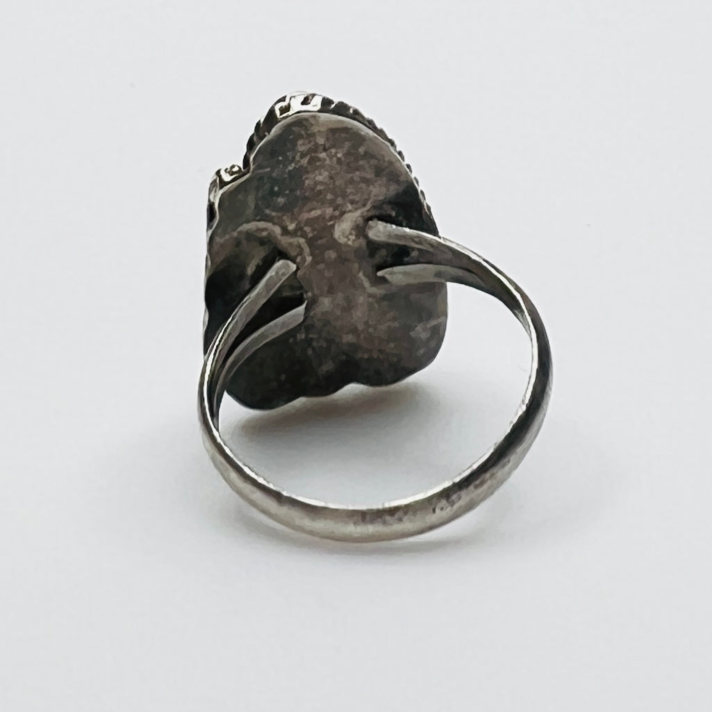 Profile of artisan silver ring with green malachite stone