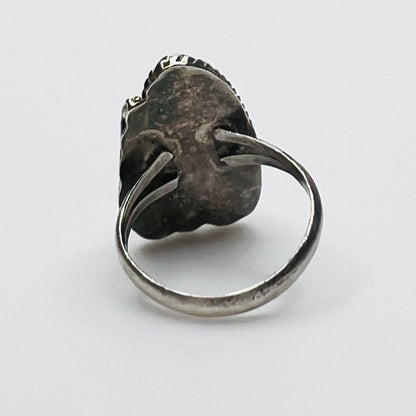 Profile of artisan silver ring with green malachite stone