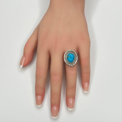Turquoise statement ring worn on hand, bold artisan silver design