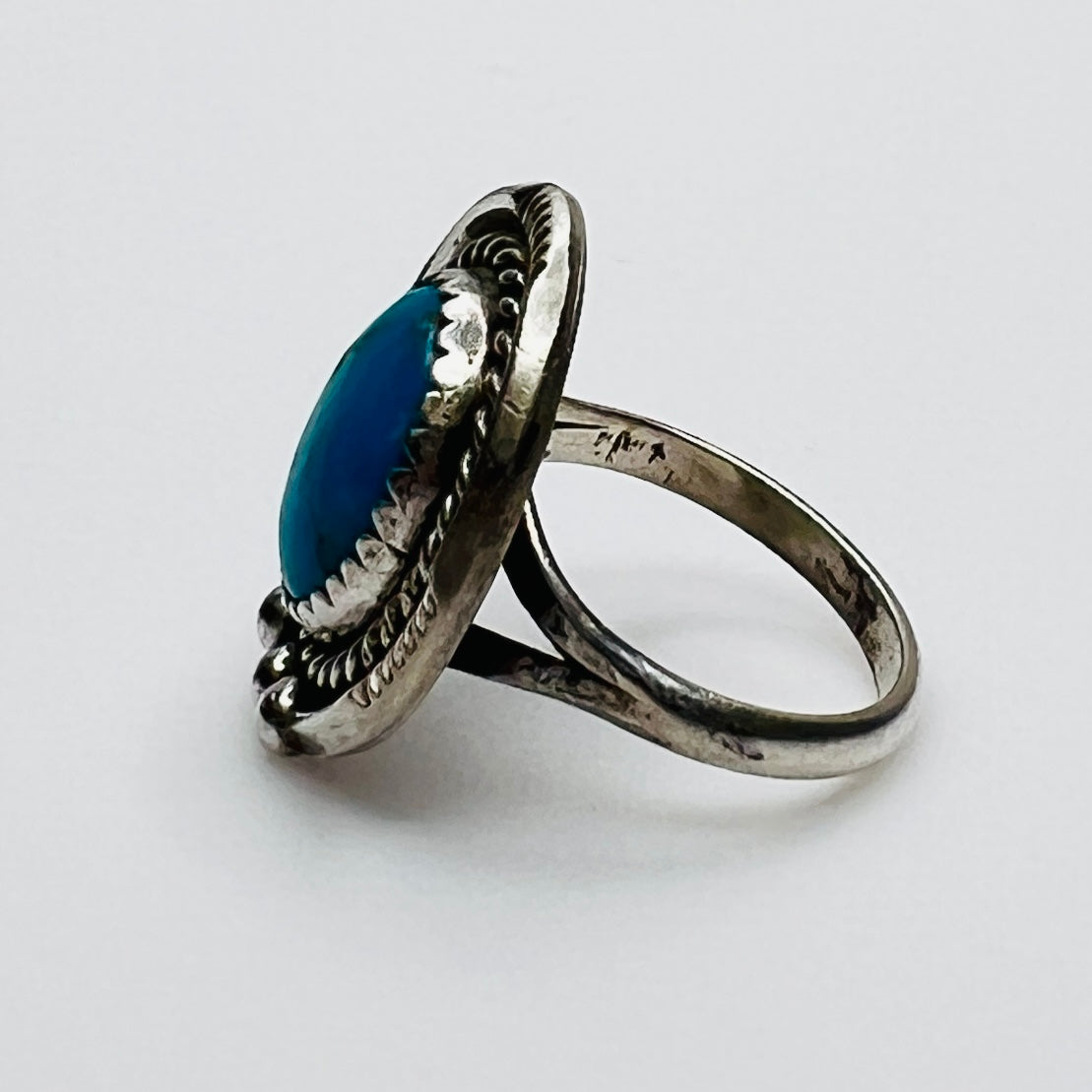 Side view of sterling silver turquoise ring with raised bezel setting
