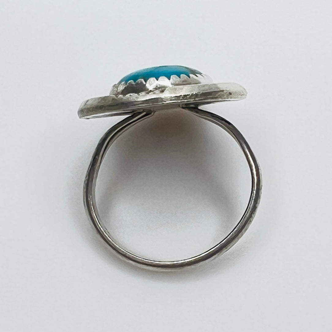 Side view of sterling silver turquoise ring with raised bezel setting