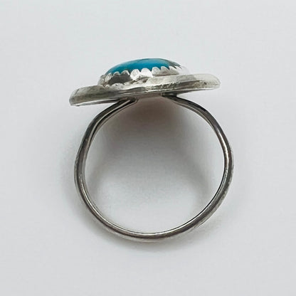 Side view of sterling silver turquoise ring with raised bezel setting