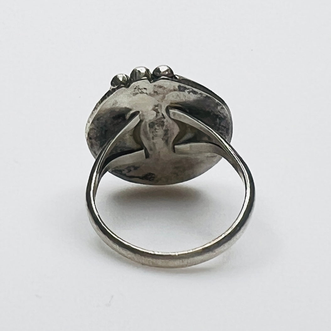 Back of vintage silver ring showing band and patina
