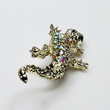 Side profile of vintage rhinestone lizard brooch showing dimensional body and tail.