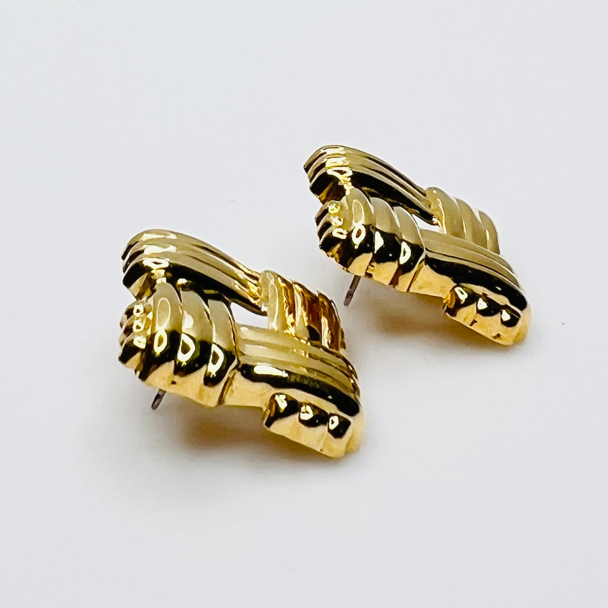 Side view of signed Avon gold tone basket weave earrings