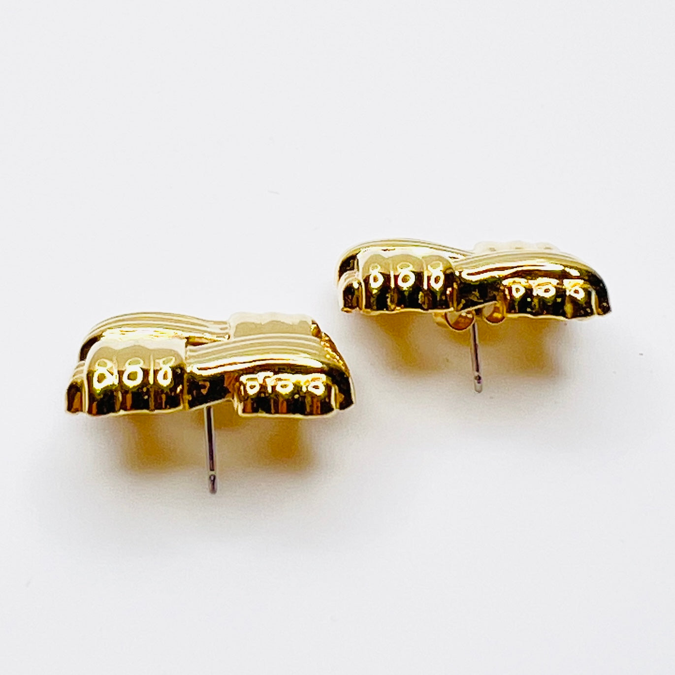 Side view of signed Avon gold tone basket weave earrings