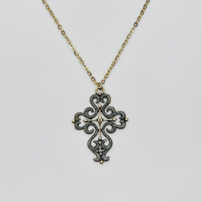 Large gold tone cross pendant necklace with textured filigree design