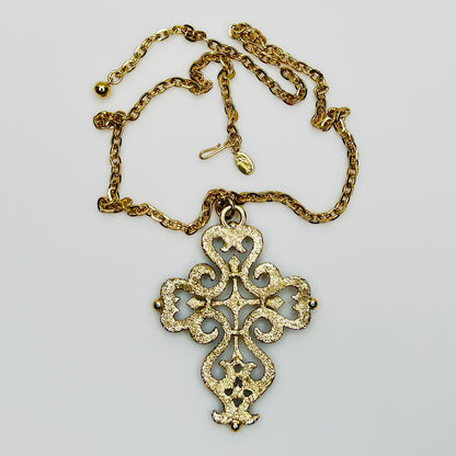 Back view of gold tone cross pendant necklace