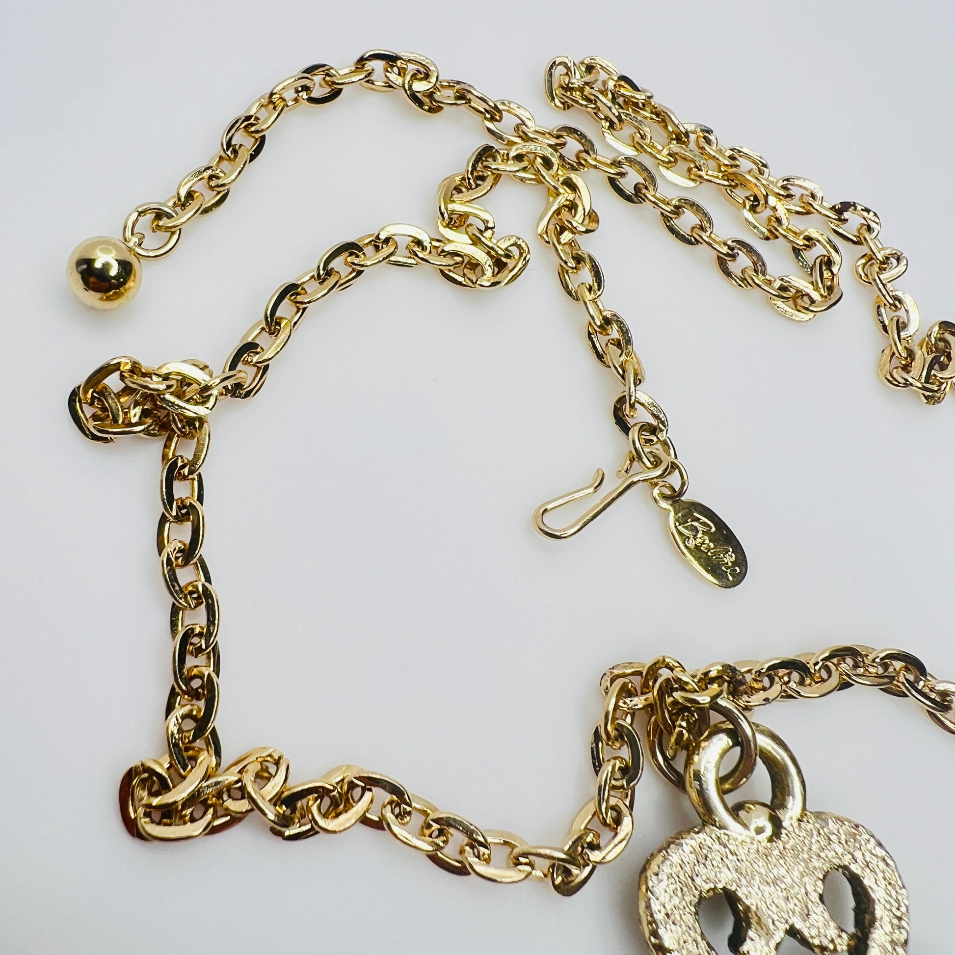 Beeline hang tag and clasp detail on gold tone chain
