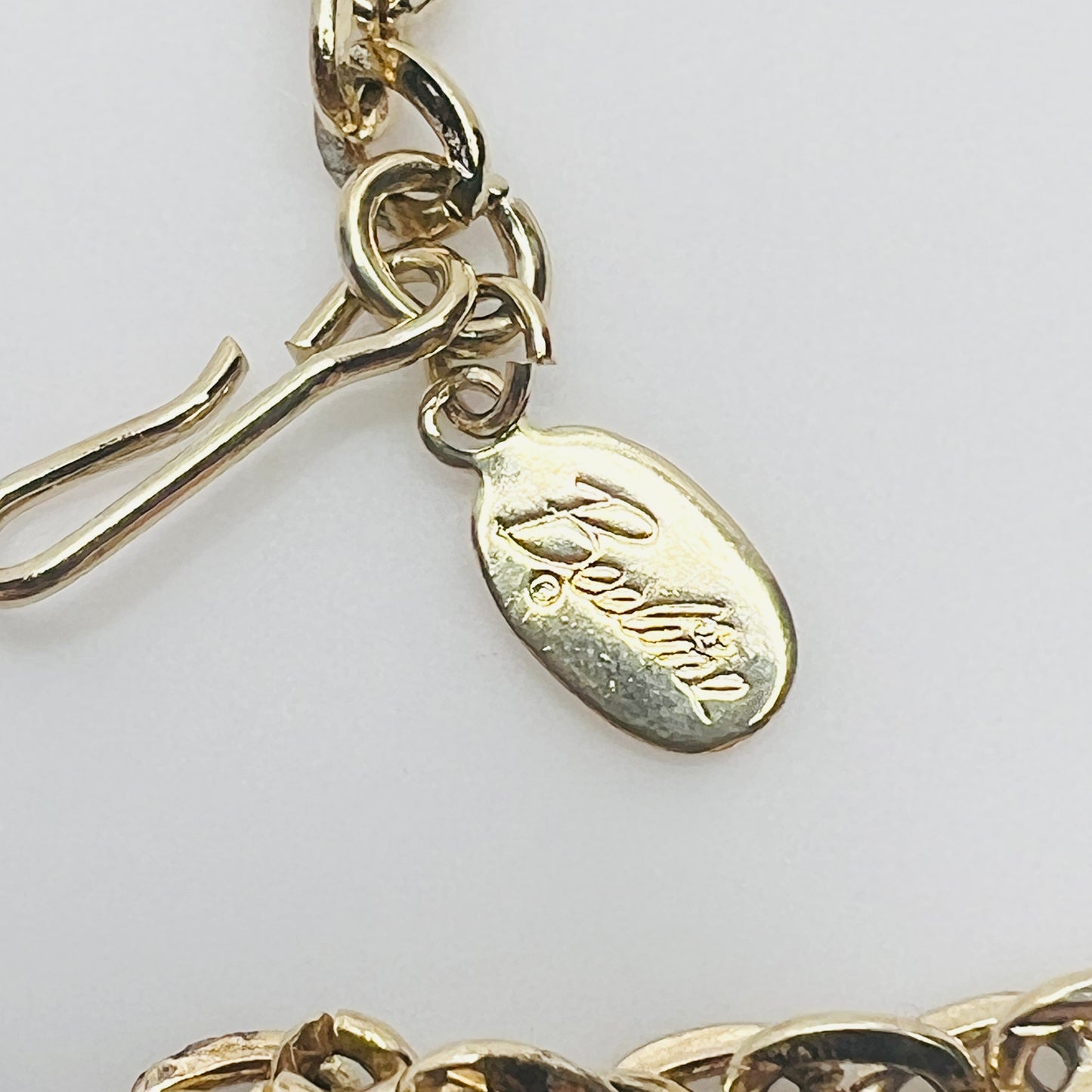 Beeline hang tag and clasp detail on gold tone chain