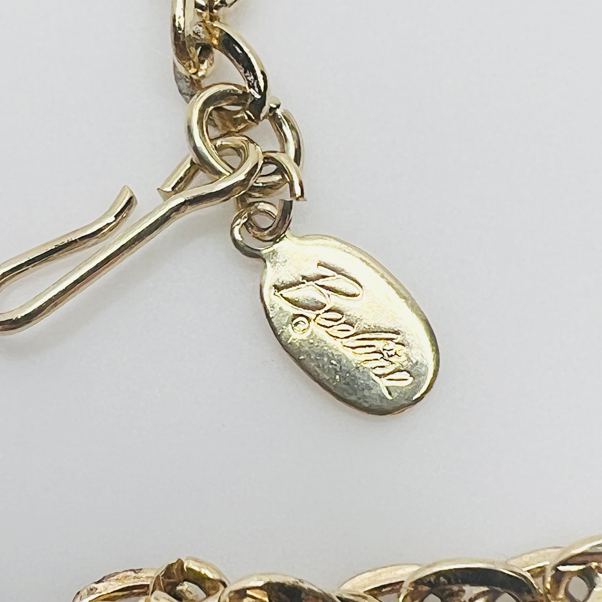 Beeline hang tag and clasp detail on gold tone chain