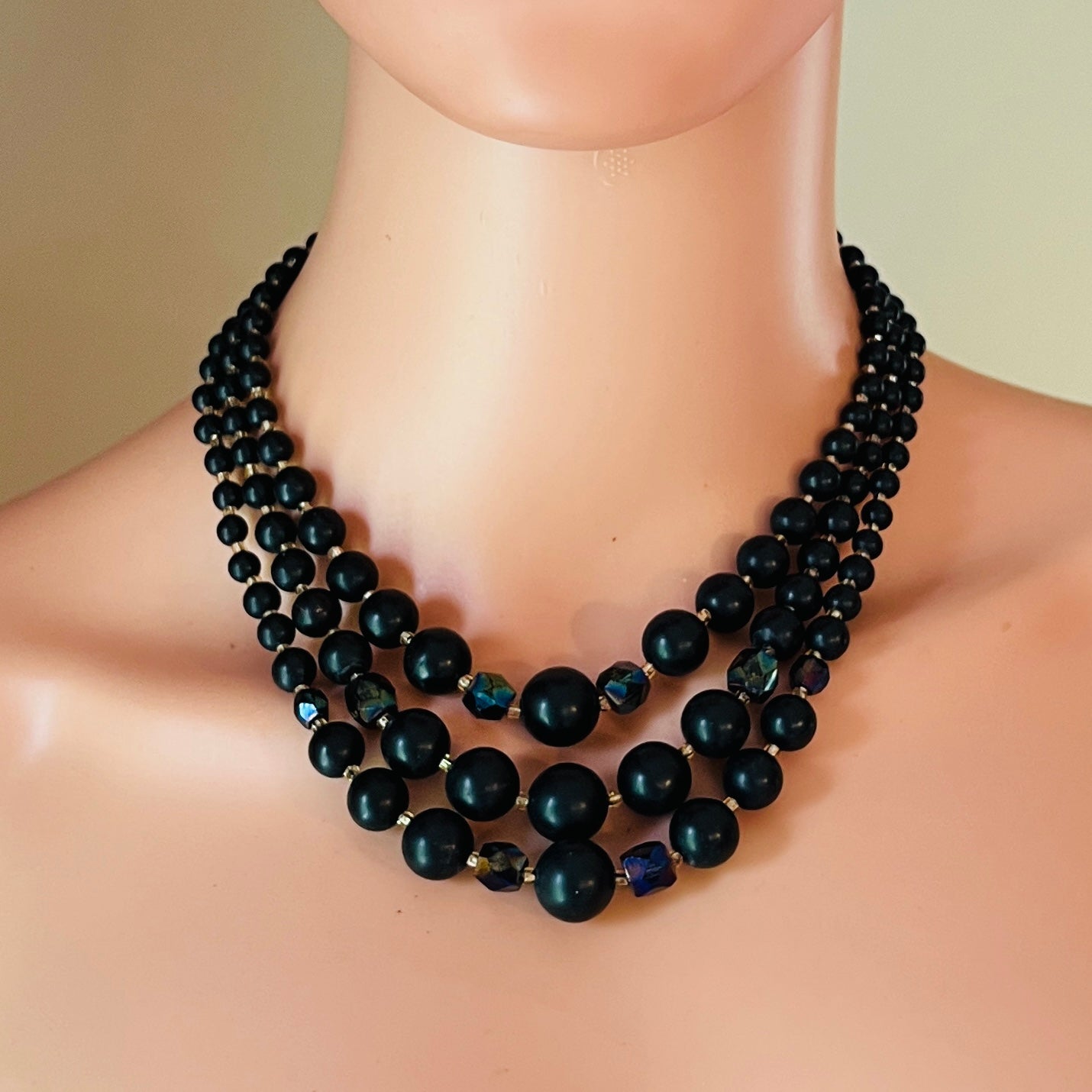 Mid-century black graduated bead necklace displayed on mannequin