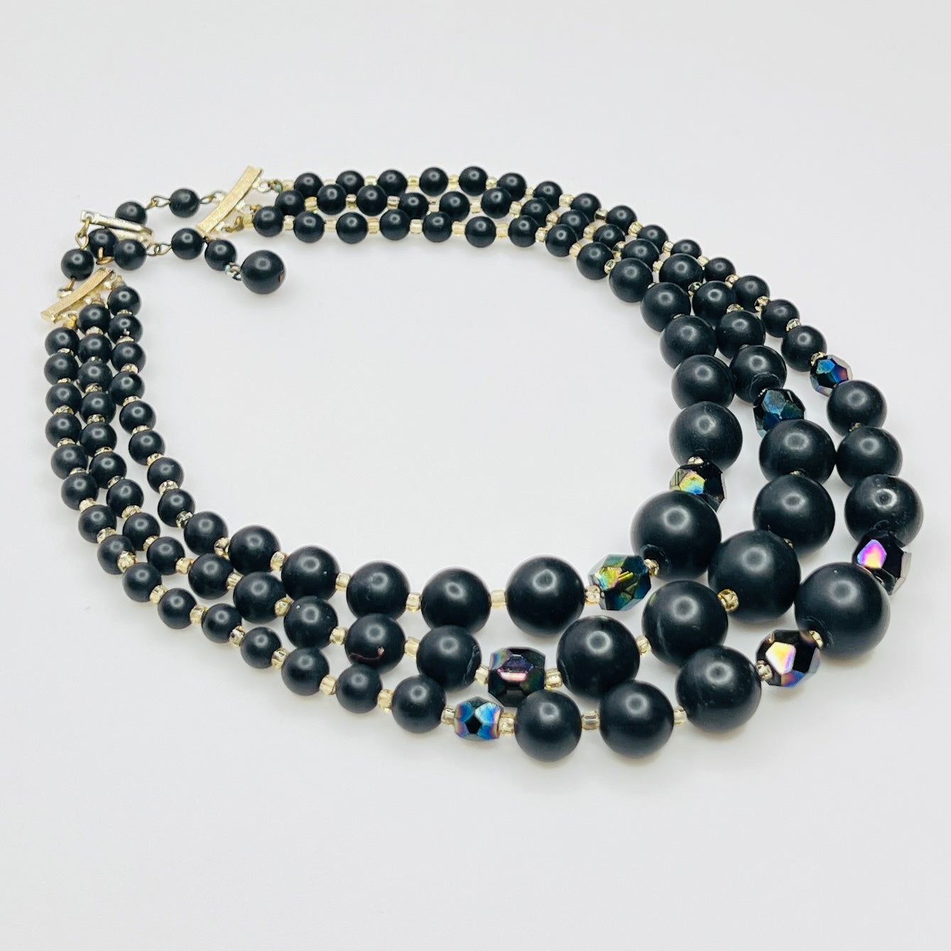 Layered matte black bead necklace with iridescent crystal accents