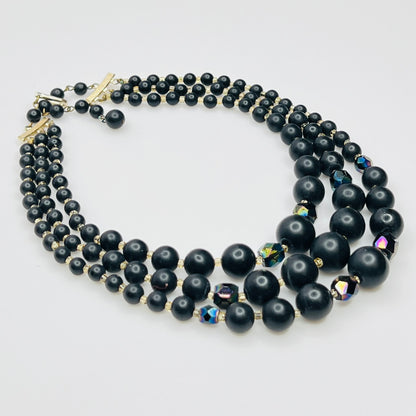 Layered matte black bead necklace with iridescent crystal accents