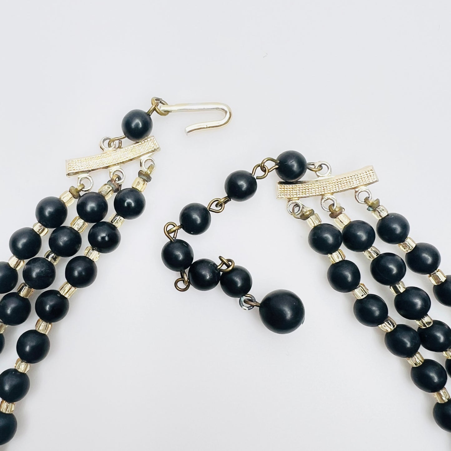 Clasp view of Layered matte black bead necklace with iridescent crystal accents