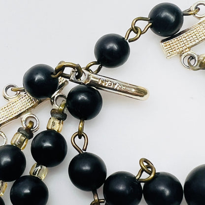 Close view of Japan stamped clasp on vintage black bead necklace