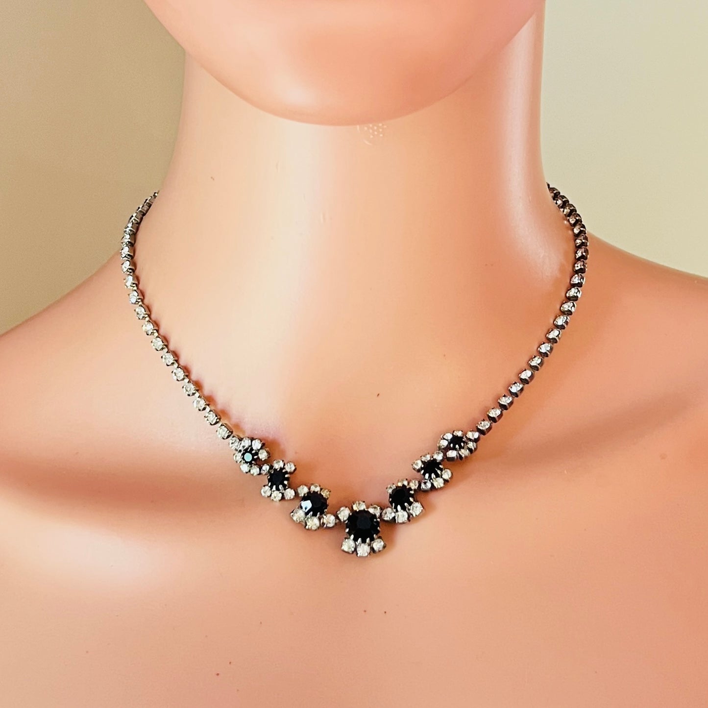 Mid-century black rhinestone floral necklace worn on mannequin display