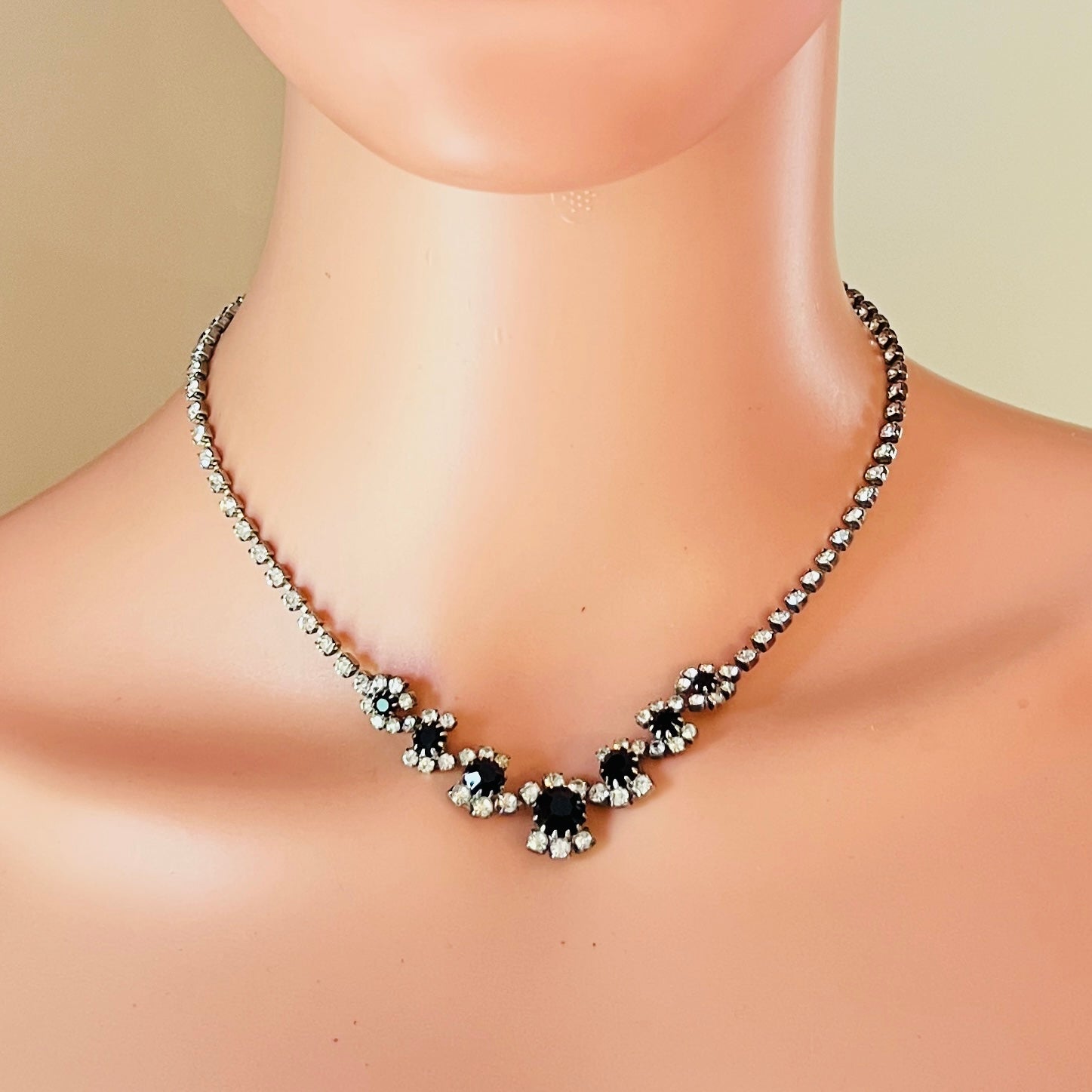 Mid-century black rhinestone floral necklace worn on mannequin display