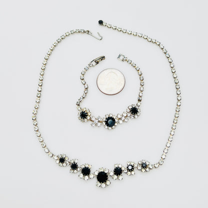 Matching 1950s rhinestone necklace and bracelet beside quarter for scale