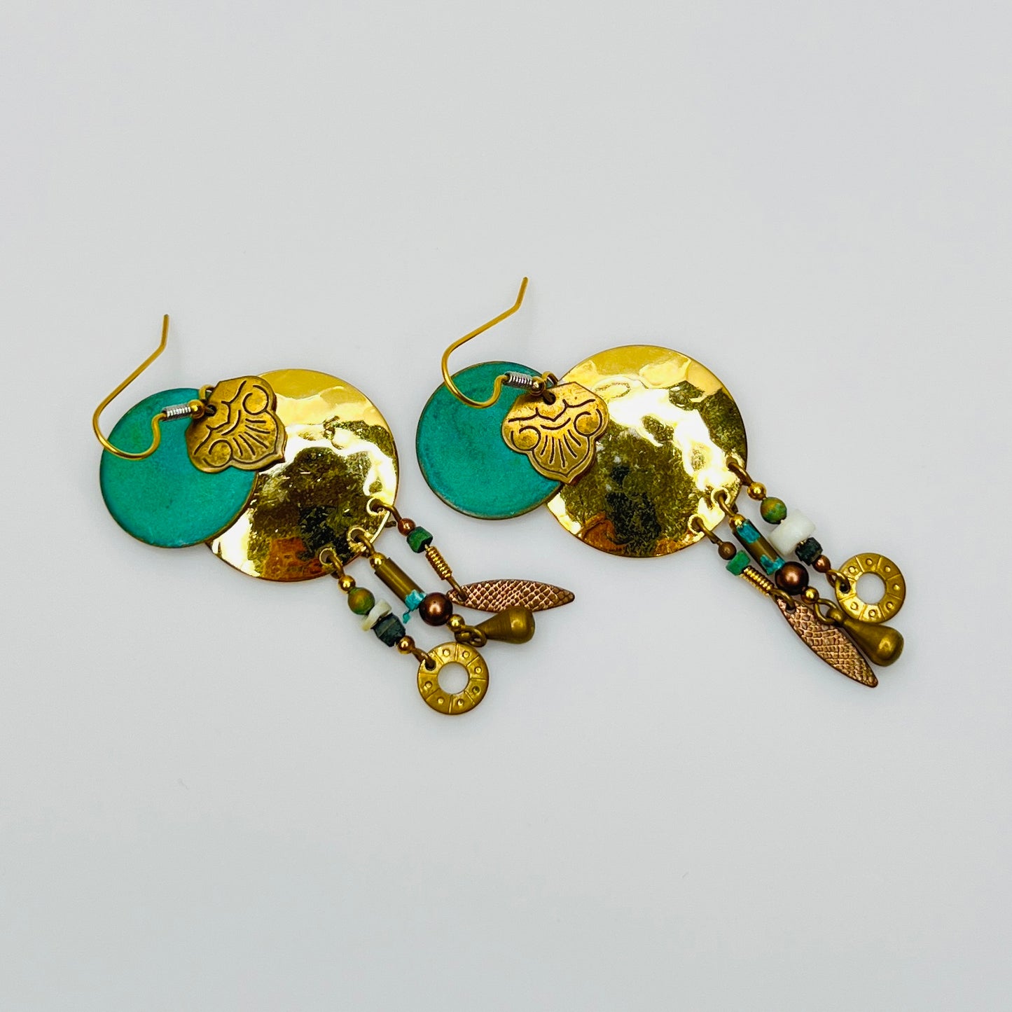 Close-up layered disc earrings with turquoise enamel center