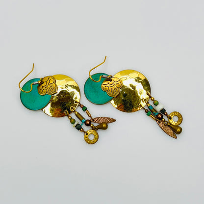 Close-up layered disc earrings with turquoise enamel center