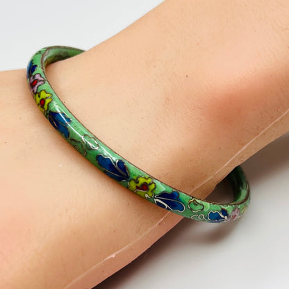 Slim floral cloisonne bracelet worn on wrist with green enamel finish