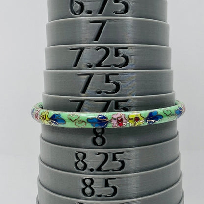 Cloisonne bangle on mandrel showing size and slim profile