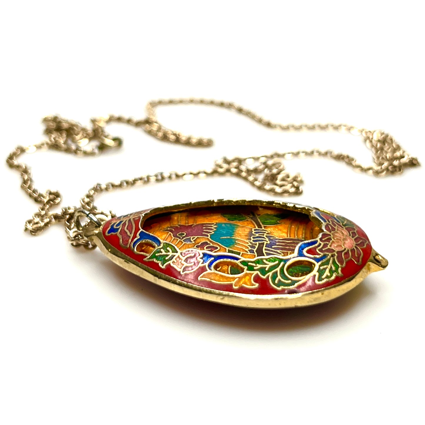 Close-up of colorful cloisonné parrot pendant with gold-tone detailing
