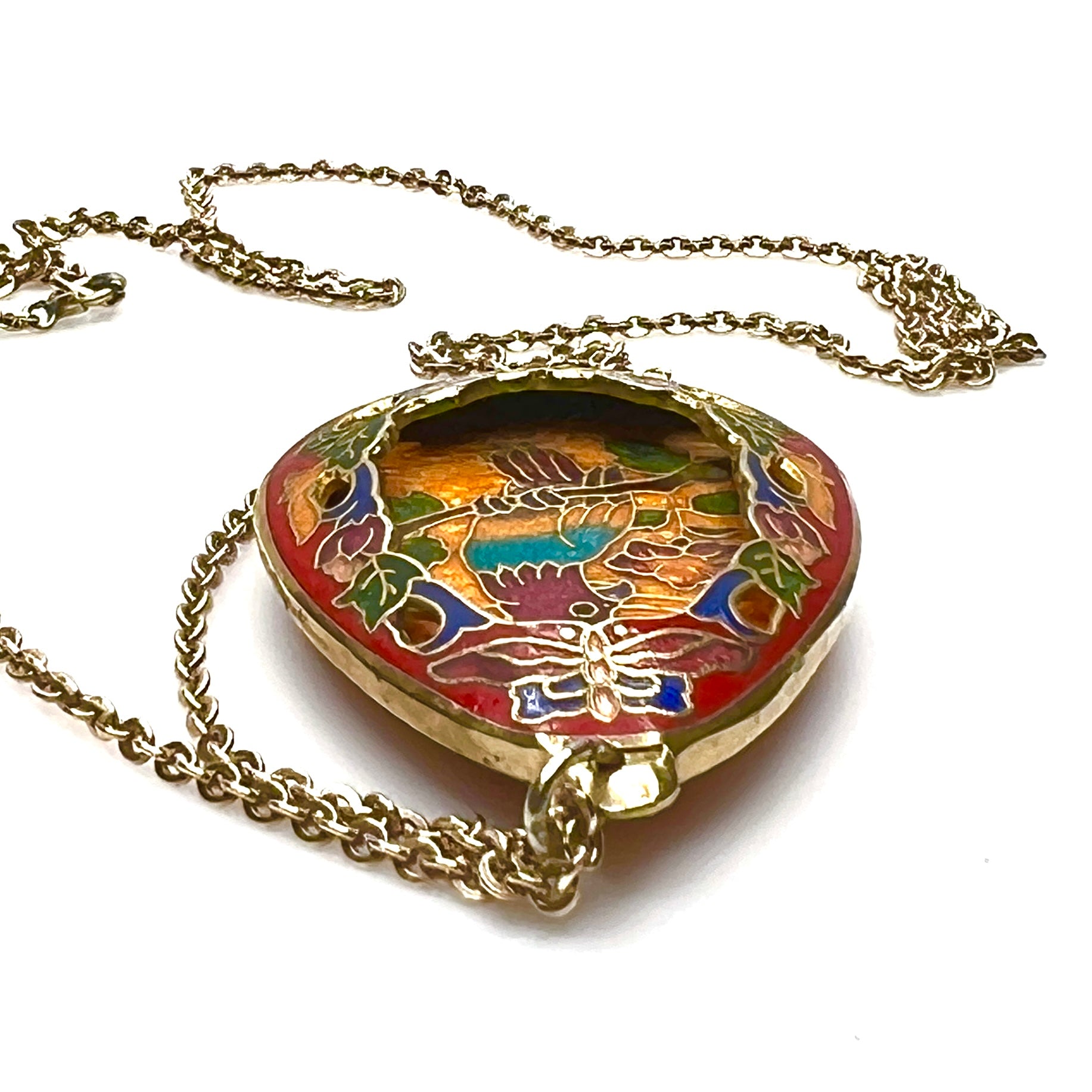 Close-up of colorful cloisonné parrot pendant with gold-tone detailing