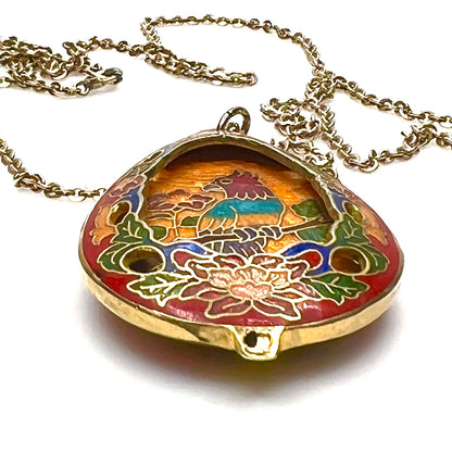 Close-up of colorful cloisonné parrot pendant with gold-tone detailing