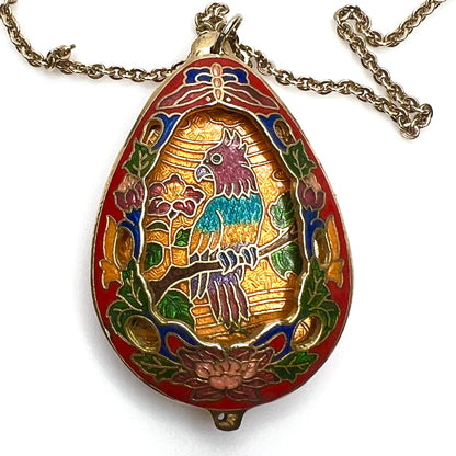 Close-up of colorful cloisonné parrot pendant with gold-tone detailing