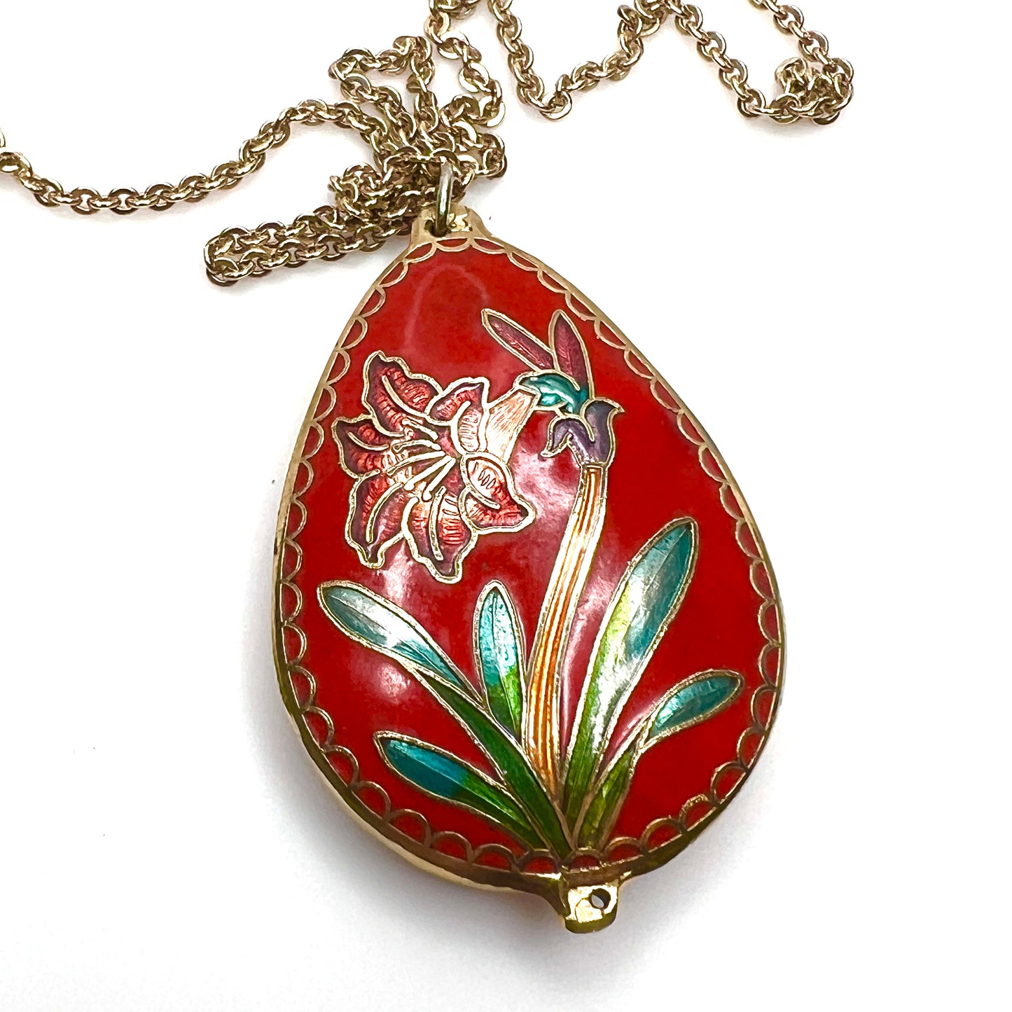 Reverse close-up of vintage cloisonné floral pendant in red enamel