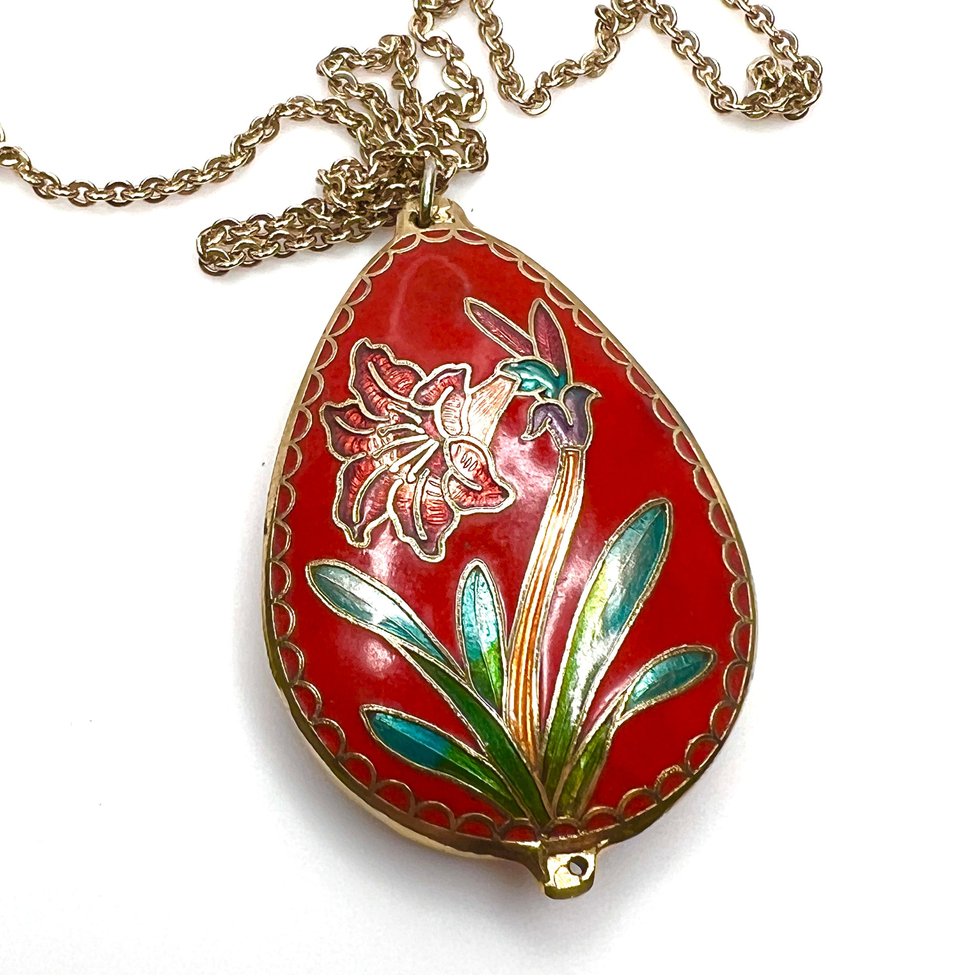 Reverse close-up of vintage cloisonné floral pendant in red enamel