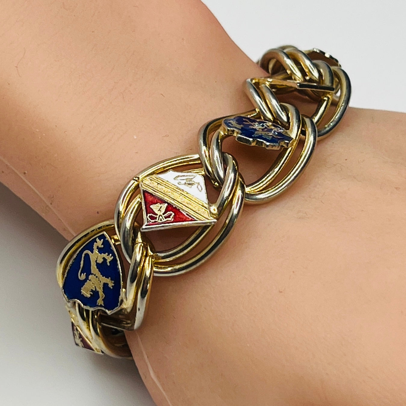 1950s coat of arms bracelet worn on wrist