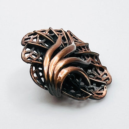 Side view of dimensional 1970s copper openwork leaf brooch