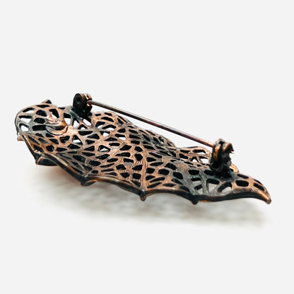 Side view of dimensional 1970s copper openwork leaf brooch
