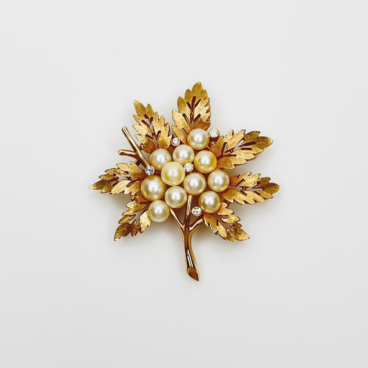 Vintage Crown Trifari gold tone leaf brooch with faux pearl cluster and rhinestones