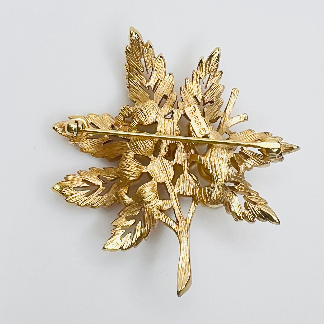 Signed Crown Trifari stamp on reverse of vintage pearl leaf brooch