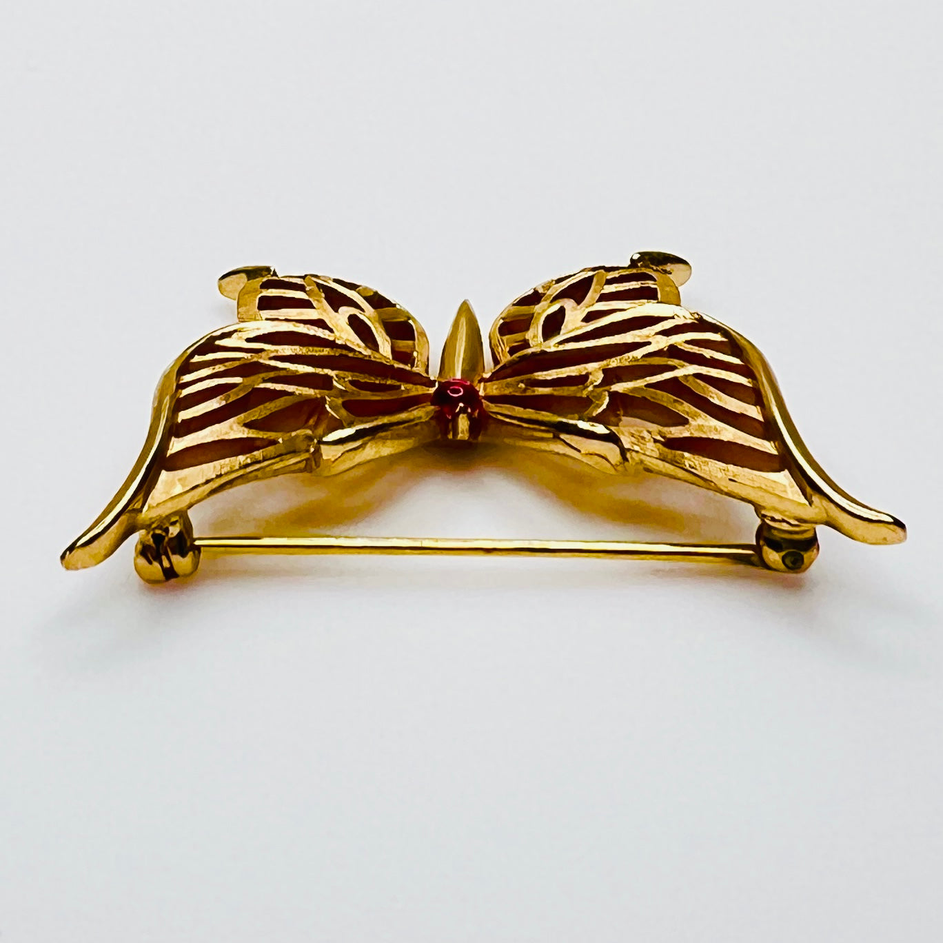 Vintage gold tone butterfly brooch with red accent