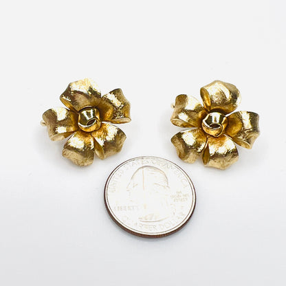 Signed Crown Trifari gold floral clip-on earrings with quarter for size.